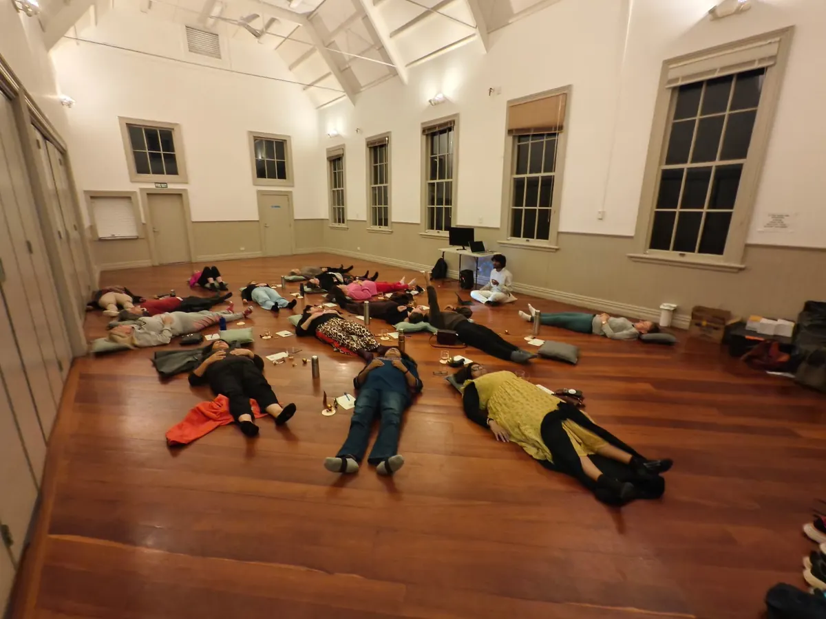 Guests taking part in a Smitea guided tea ritual in an Auckland community hall