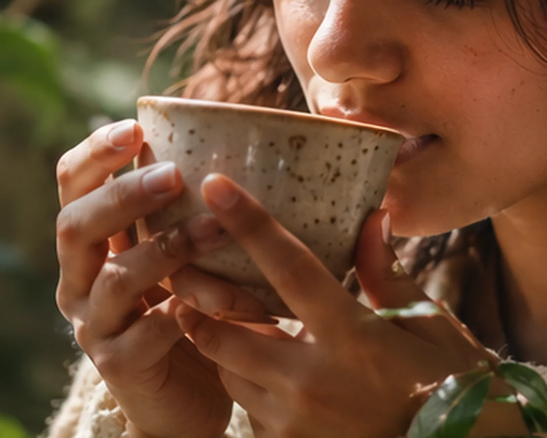 Someone enjoying tea slowly in a quiet moment